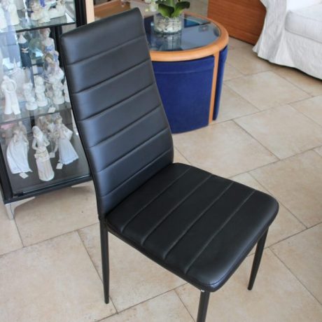 Four Matching Black Faux Leather Cushioned Chairs